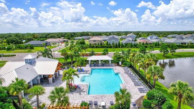 view of pool featuring a water view and a patio area