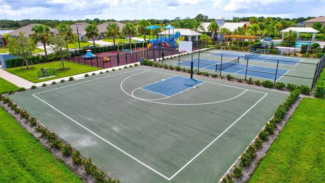 view of basketball court featuring a playground, tennis court, and a lawn