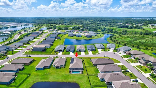 birds eye view of property with a water view and a residential view