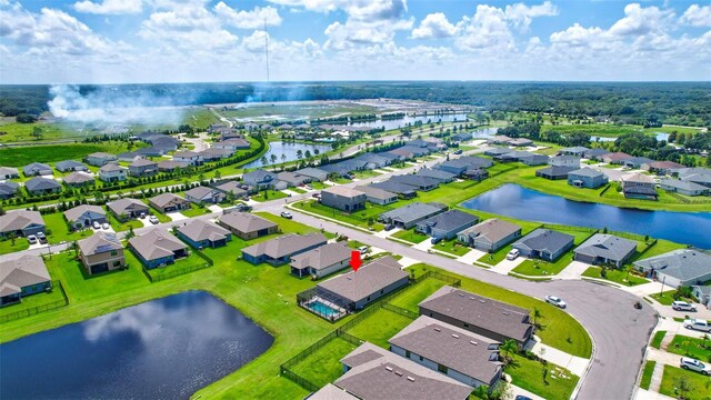 birds eye view of property with a water view