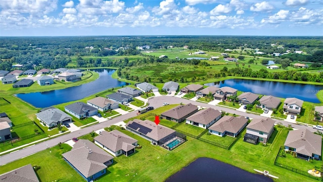 drone / aerial view featuring a residential view and a water view