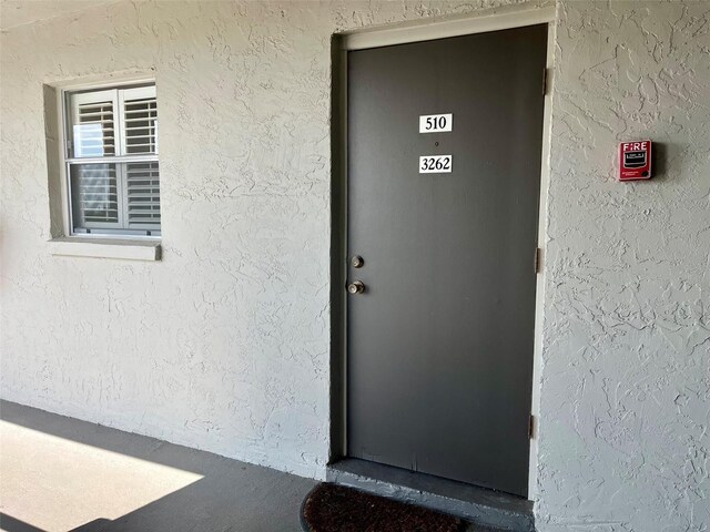 entrance to property with stucco siding