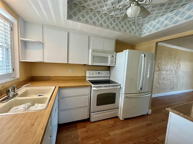 kitchen featuring a ceiling fan, a sink, dark wood-type flooring, white appliances, and white cabinetry