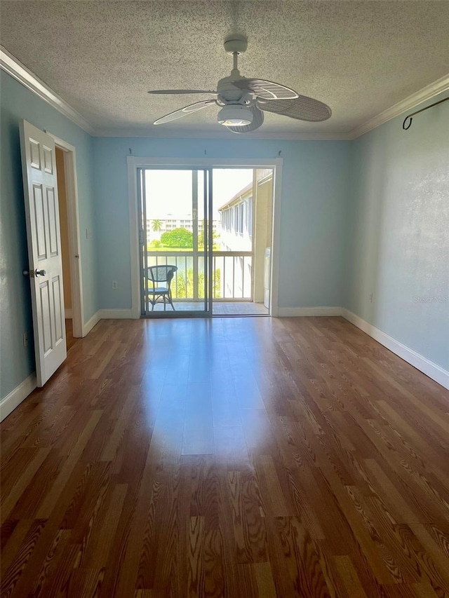 unfurnished room with crown molding, wood finished floors, a textured ceiling, and a ceiling fan