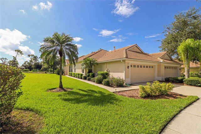 view of front facade with a garage and a front lawn