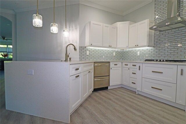 kitchen with stainless steel gas cooktop, wall chimney exhaust hood, white cabinetry, and light hardwood / wood-style floors