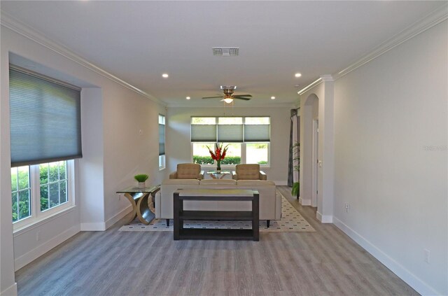 office space with a wealth of natural light, crown molding, ceiling fan, and wood-type flooring