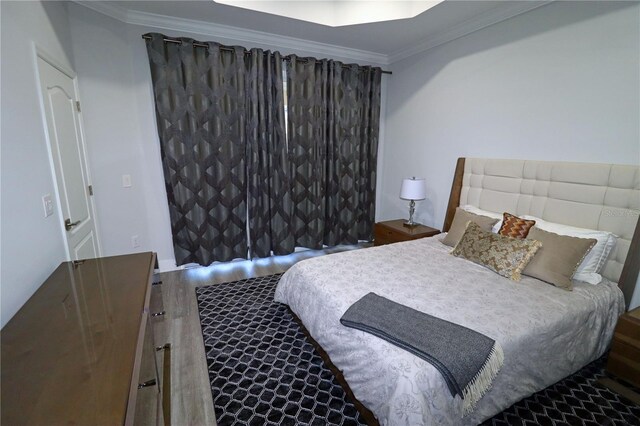 bedroom with crown molding and hardwood / wood-style floors