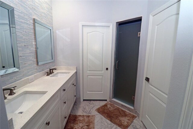 bathroom with backsplash, walk in shower, and vanity