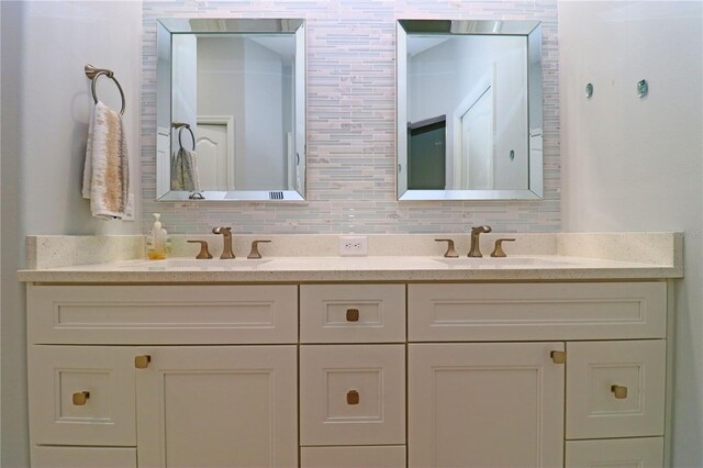 bathroom with vanity and tasteful backsplash