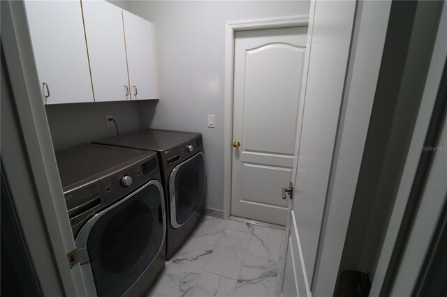 washroom featuring cabinets and independent washer and dryer