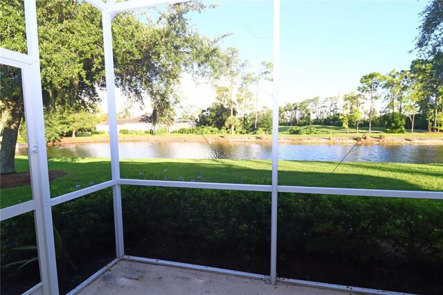 unfurnished sunroom with a water view