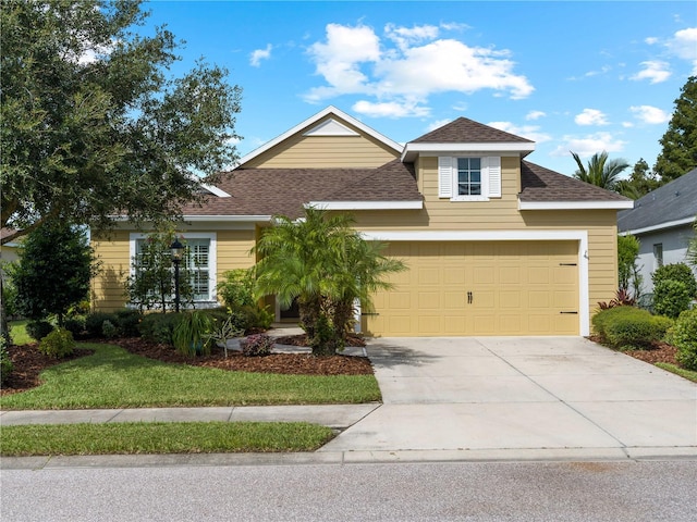 view of front facade featuring a garage and a front lawn