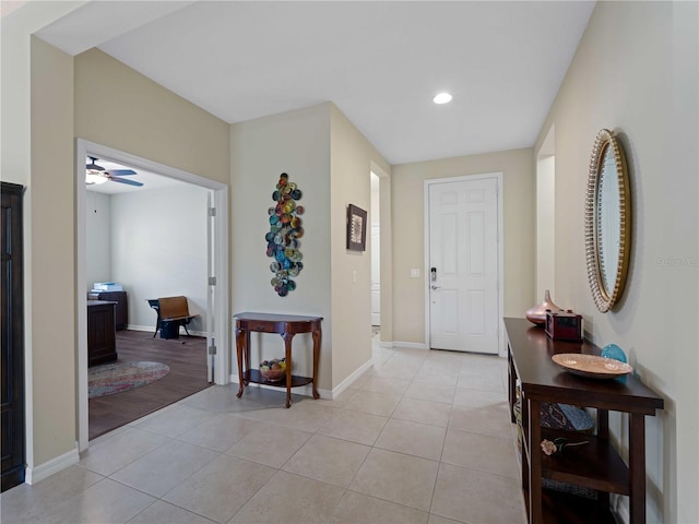 foyer entrance with light hardwood / wood-style floors and ceiling fan