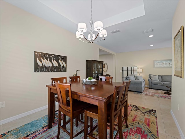 tiled dining area featuring a notable chandelier