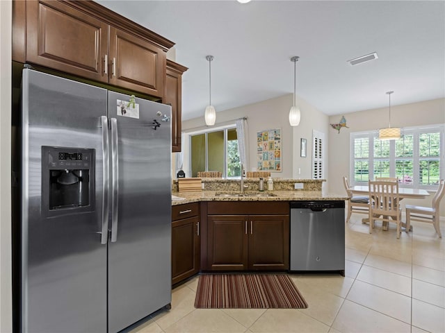 kitchen with pendant lighting, a healthy amount of sunlight, sink, and appliances with stainless steel finishes