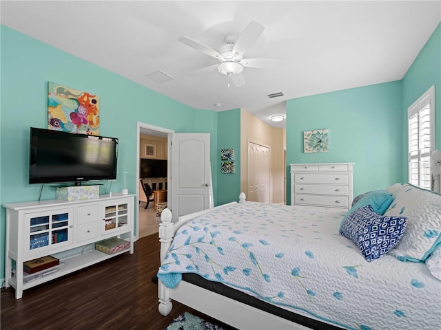 bedroom featuring a closet, dark wood-type flooring, and ceiling fan