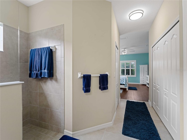 bathroom with tile patterned floors, ceiling fan, and a tile shower