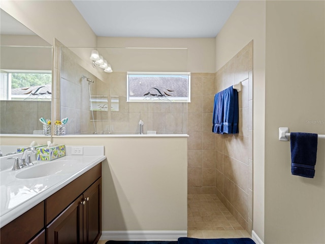 bathroom featuring a tile shower and vanity