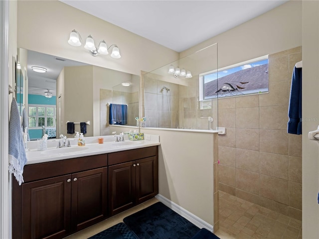 bathroom with a tile shower and vanity