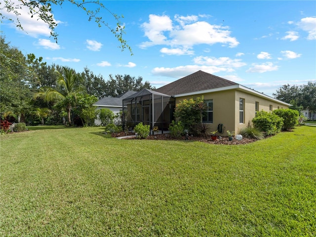 rear view of house featuring a lanai and a yard