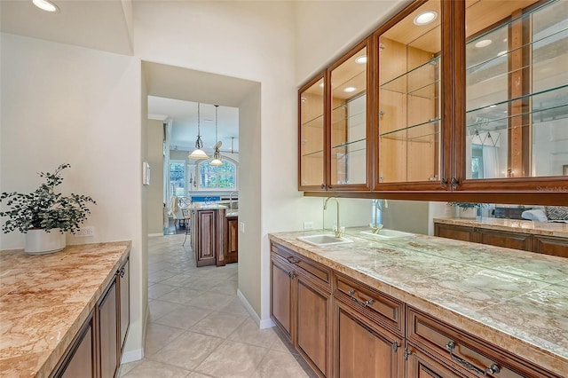 bar featuring hanging light fixtures, sink, and light tile patterned flooring