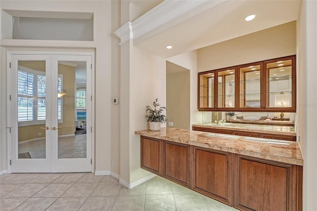 bathroom featuring tile patterned floors, french doors, and vanity