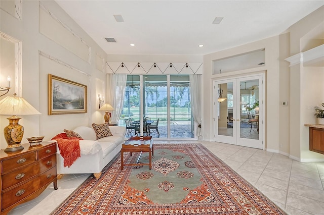 living room featuring light tile patterned flooring and french doors