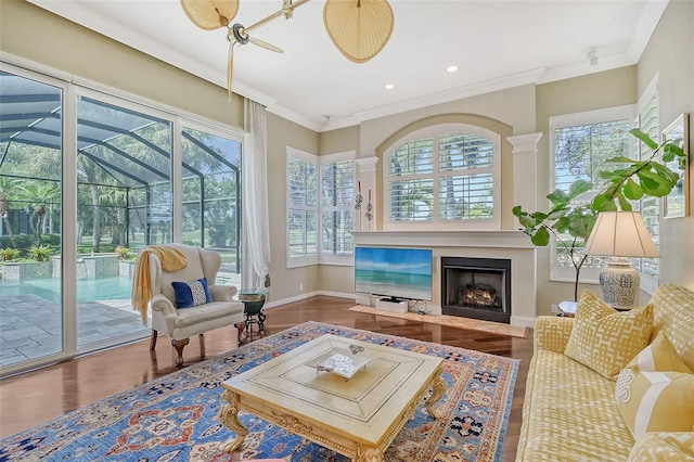 sunroom / solarium featuring ceiling fan