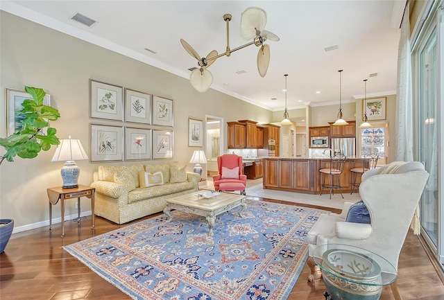 living room with crown molding and dark wood-type flooring