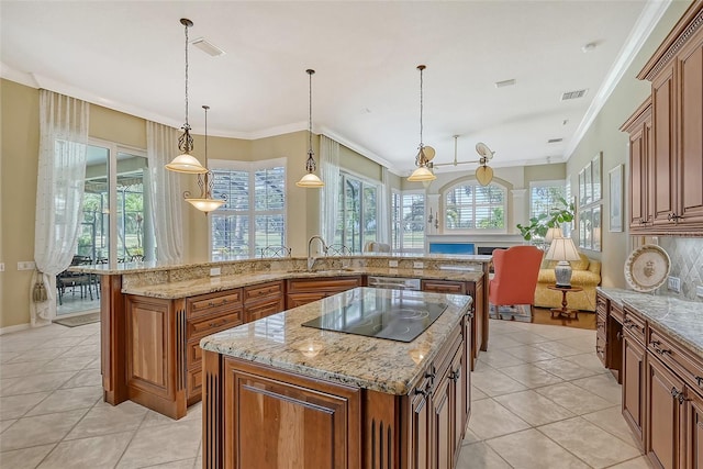 kitchen featuring a wealth of natural light, hanging light fixtures, and a spacious island