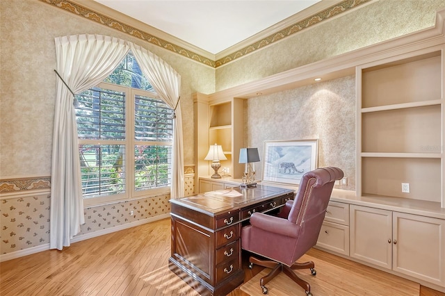 office featuring crown molding, built in features, light hardwood / wood-style floors, and plenty of natural light