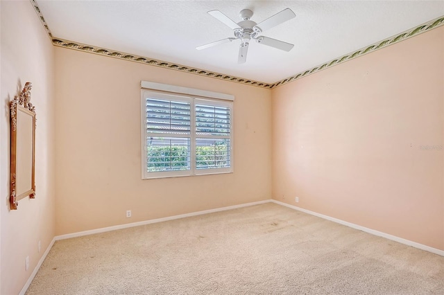 unfurnished room with light colored carpet and ceiling fan