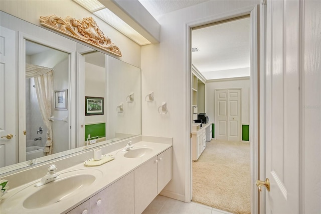 bathroom featuring tile patterned flooring, a textured ceiling, vanity, and  shower combination