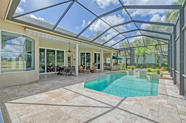 view of pool with a lanai, a patio area, ceiling fan, and a hot tub