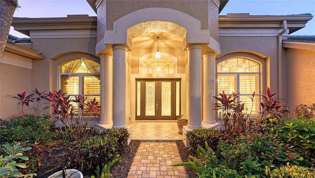 view of exterior entry featuring french doors