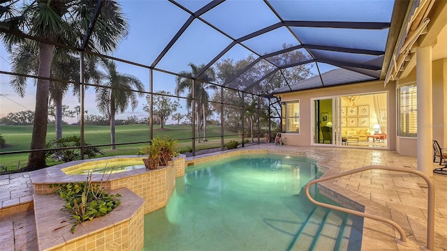 pool at dusk with glass enclosure, an in ground hot tub, and a patio