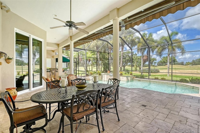 sunroom / solarium with ceiling fan and a swimming pool