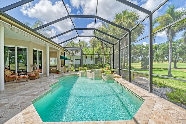 view of swimming pool with glass enclosure, a jacuzzi, and a patio