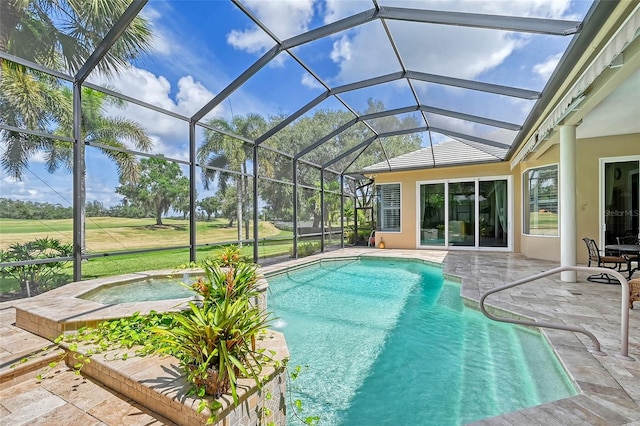 view of swimming pool with glass enclosure, a patio, and a hot tub