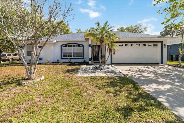 single story home featuring a garage and a front lawn