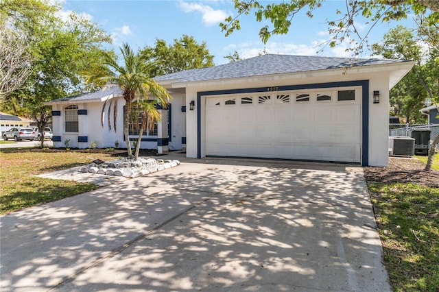 ranch-style house featuring central AC and a garage