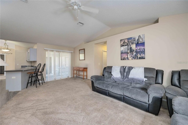 living room featuring ceiling fan, light colored carpet, a textured ceiling, and lofted ceiling