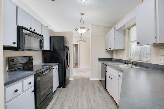 kitchen featuring light hardwood / wood-style floors, white cabinetry, black appliances, decorative light fixtures, and sink