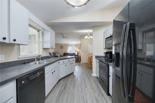 kitchen with white cabinets, vaulted ceiling, black appliances, ceiling fan with notable chandelier, and light hardwood / wood-style floors