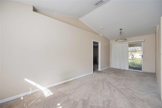 unfurnished room with lofted ceiling, light colored carpet, and a notable chandelier