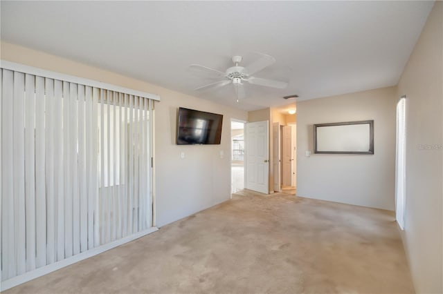 carpeted empty room featuring ceiling fan