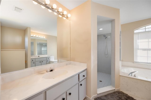 bathroom featuring shower with separate bathtub and vanity