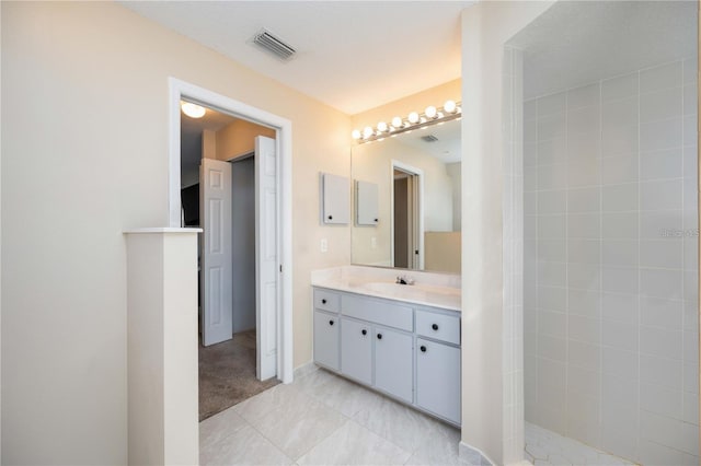 bathroom featuring walk in shower and vanity