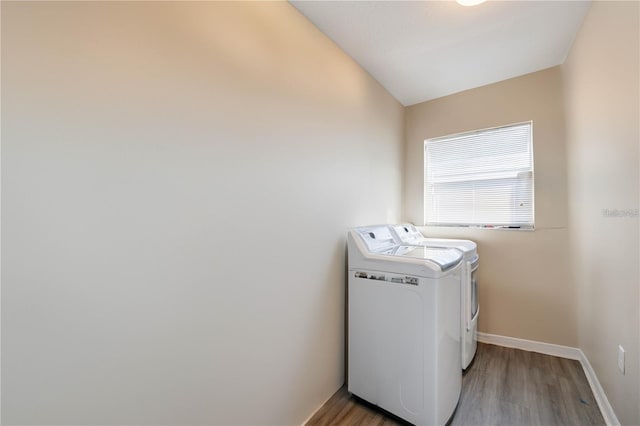 clothes washing area with hardwood / wood-style floors and separate washer and dryer